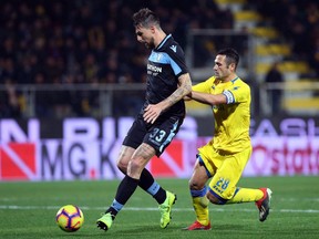 Lazio's Francesco Acerbi, left, vies for the ball with Frosinone's Camillo Ciano during the Serie A soccer match between Frosinone and Lazio at the Benito Stirpe stadium in Frosinone, Italy, Monday, Feb. 4, 2019.