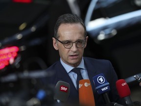 Germany's Foreign Minister Heiko Maas speaks with the media as he arrives to an EU Foreign Ministers meeting at the European Council headquarters in Brussels, Monday, Feb. 18, 2019. US President Donald Trump's demand that European countries take back their nationals fighting in Syria is receiving mixed reactions, as nations pondered how to bring home-grown Islamic State extremists to trial.