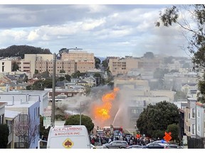 Flames burn at an intersection in San Francisco, Wednesday, Feb. 6, 2019. An explosion on a gas line has set at least one San Francisco building on fire and is sending huge plumes of fire and smoke into the air, prompting evacuations of nearby buildings.