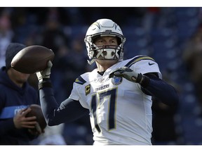 FILE - In this Sunday, Jan. 13, 2019, file photo, Los Angeles Chargers quarterback Philip Rivers warms up before an NFL divisional playoff football game against the New England Patriots in Foxborough, Mass. Rivers fought back tears as he accepted an award from the San Diego Sports Association at its annual Salute to the Champions dinner Thursday, Jan. 31, 2019.