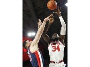 Georgia forward Derek Ogbeide (34) takes a shot over Mississippi center Dominik Olejniczak (13) during an NCAA college basketball game in Athens, Ga., on Saturday, Feb. 9, 2019.