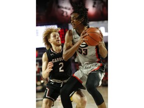 Georgia forward Nicolas Claxton (33) tries to get by South Carolina guard Hassani Gravett (2) during an NCAA college basketball game  in Athens, Ga., on Saturday, Feb. 2, 2019.