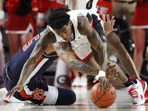 Georgia guard Tyree Crump competes with Auburn forward Chuma Okeke (5) for the ball duringan NCAA college basketball game Wednesday, Feb. 27, 2019, in Athens, Ga.