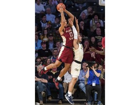 Florida State guard Anthony Polite (13) rebounds a ball over Georgia Tech guard Jose Alvarado (10) during the first half of an NCAA college basketball game Saturday, Feb. 16, 2019, in Atlanta.