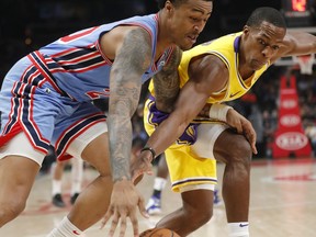 Los Angeles Lakers guard Rajon Rondo (9) reaches in to knock the ball away from Atlanta Hawks forward John Collins (20) during the first half of an NBA basketball game Tuesday, Feb. 12, 2019, in Atlanta.