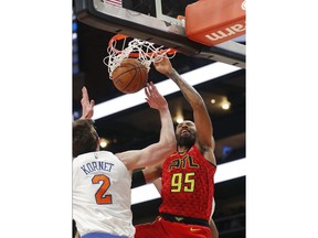 Atlanta Hawks forward DeAndre' Bembry (95) scores as New York Knicks forward Luke Kornet (2) defends during the first half of an NBA basketball game Thursday, Feb. 14, 2019, in Atlanta.