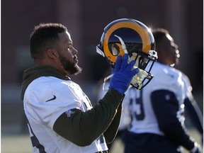 Los Angeles Rams defensive end Aaron Donald (99) puts his helmet on after a stretching period during practice for the NFL Super Bowl 53 football game against the New England Patriots, Thursday, Jan. 31, 2019, in Flowery Branch, Ga.