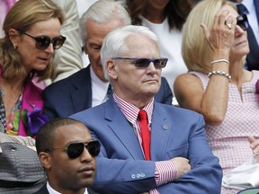 Canada's High Commissioner to London Gordon Campbell, center, sits in the Royal Box on centre court prior to the women's singles final between Eugenie Bouchard of Canada and Petra Kvitova of the Czech Republic at the All England Lawn Tennis Championships in Wimbledon, London, Saturday July 5, 2014.