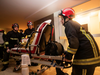 This handout picture taken and released by the Paris firefighters brigade (BSPP) in the night of February 5, 2019 shows firemen carrying a person and her cat on a gurney in an hospital following a fire that killed 8 in a building in Erlanger street in the 16th arrondissement in Paris.