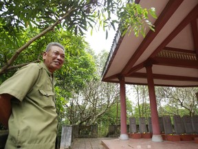 In this Feb. 16, 2019, photo, veteran Duong Van Dau smiles while standing at a memorial for North Korean fallen pilots in Bac Giang province, Vietnam. The fourteen headstones of the pilots who died while fighting American bombers alongside the Vietnamese army during the Vietnam war remain as a symbol of Vietnam-North Korea friendship.