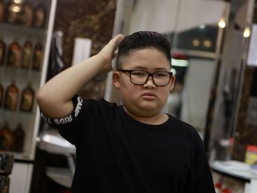 To Gia Huy, 9 checks his hair after having a Kim haircut in Hanoi, Vietnam, on Tuesday, Feb. 19, 2019. U.S. President Donald Trump and North Korean leader Kim Jong Un have become the latest style icons in Hanoi, a week before their second summit is to be held in the capital city of Vietnam.