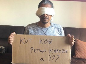 Gilbert Mibrambeau Jr. is seen in this undated handout photo. In a photo posted to Twitter last summer, Gilbert Mirambeau Jr. sits on a couch in Montreal, wearing a blindfold and holding up a handwritten cardboard sign written in Creole that reads: "Where is the PetroCaribe money?"