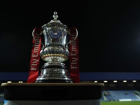 The English FA Cup trophy is placed on the pitch before the 5th round soccer match between Queens Park Rangers and Watford at Loftus Road stadium in London, Friday, Feb. 15, 2019.