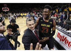 Maryland forward Bruno Fernando (23) celebrates with coach Mark Turgeon after an NCAA college basketball game against Iowa, Tuesday, Feb. 19, 2019, in Iowa City, Iowa. Maryland won 66-65.