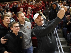 Former Iowa State head coach Fred Hoiberg, center, takes a photo with fans before the Iowa State NCAA college basketball game against Baylor, Tuesday, Feb. 19, 2019, in Ames, Iowa.