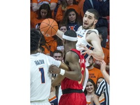Illinois forward Giorgi Bezhanishvili (15) looks to pass out a offensive rebound to Illinois guard Trent Frazier (1) who is being guarded by Nebraska guard Glynn Watson Jr. (5) during an NCAA college basketball game in Champaign, Ill., Saturday. Feb. 2, 2019.