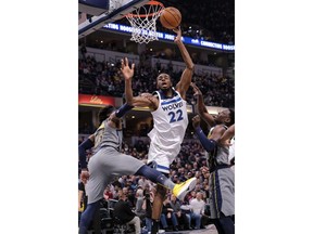 Minnesota Timberwolves forward Andrew Wiggins (22) is fouled by Indiana Pacers guard Wesley Matthews (23) during the first half of an NBA basketball game in Indianapolis, Thursday, Feb. 28, 2019.