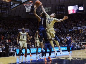Purdue guard Sasha Stefanovic (55) fouls Illinois guard Alan Griffin (0) during the first half of an NCAA college basketball game in West Lafayette, Ind., Wednesday, Feb. 27, 2019.