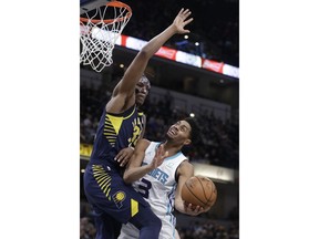 Charlotte Hornets' Jeremy Lamb (3) puts up a shot against Indiana Pacers' Myles Turner during the first half of an NBA basketball game, Monday, Feb. 11, 2019, in Indianapolis.