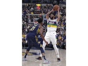 New Orleans Pelicans forward Anthony Davis (23) looks to pass the ball as Indiana Pacers forward Thaddeus Young (21) during the first half of an NBA basketball game in Indianapolis, Friday, Feb. 22, 2019.