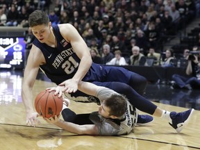 Penn State forward John Harrar (21) and Purdue guard Sasha Stefanovic (55) go for the ball during the first half of an NCAA college basketball game in West Lafayette, Ind., Saturday, Feb. 16, 2019.