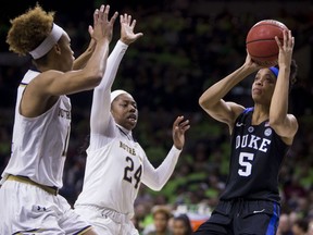 Duke's Leaonna Odom (5) goes up to shoot in front of Notre Dame's Brianna Turner, left, and Arike Ogunbowale (24) during the first half of an NCAA college basketball game Thursday, Feb. 21, 2019, in South Bend, Ind.