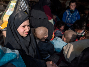 Women and children displaced from Deir Ezzor sit in the back of a truck after they fled the Islamic State holdout near Baghuz, Syria, on Feb. 11, 2019.