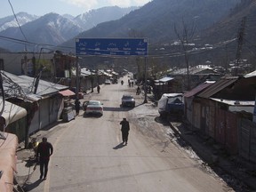 Pakistani Kashmiris walk through the closed main market, following the intense exchange of fire between Pakistan and India at the border town of Chakoti at the Line of Control in Pakistani Kashmir, Wednesday, Feb. 27, 2019. Pakistan's air force shot down two Indian warplanes after they crossed the boundary between the two nuclear-armed rivals in the disputed territory of Kashmir on Wednesday and captured one Indian pilot, a military spokesman said.