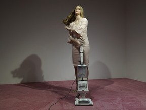 An Ivanka Trump lookalike vacuums crumbs thrown by spectators at Jennifer Rubell's art exhibit "Ivanka Vacuuming 2019" on Tuesday, Feb. 5, 2019, at Flashpoint Gallery in Washington.