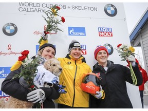 Germany's Tina Hermann, centre, celebrates her victory with second place finisher Canada's Mirela Rahneva, left, and third place finisher Great Britain's Laura Deas following the women's World Cup skeleton event in Calgary, Saturday, Feb. 23, 2019.