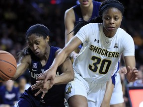 Connecticut guard Crystal Dangerfield, left, and Wichita State guard Cesaria Ambrosio (30) chase the ball during the second half of an NCAA college basketball game in Wichita, Kan., Tuesday, Feb. 26, 2019. UConn won 84-47.