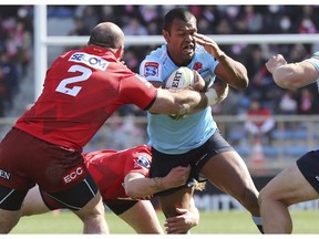 Waratahs' Curtly Beale runs with the ball during their Super Rugby match against Sunwolves in Tokyo, Saturday, Feb. 23, 2019. Waratahs won the match 31-30.