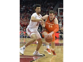 Clemson forward David Skara (24) attempts to drive past the defense of Louisville forward Jordan Nwora (33) during the first half of an NCAA college basketball game in Louisville, Ky., Saturday, Feb. 16, 2019.