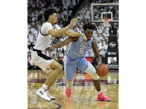 North Carolina forward Nassir Little (5) drives around the defense of Louisville forward Jordan Nwora (33) during the first half of an NCAA college basketball game in Louisville, Ky., Saturday, Feb. 2, 2019.