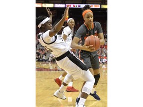 Louisville guard Jazmine Jones, left, takes a charge from Syracuse guard Kadiatou Sissoko, right,during the first half of an NCAA college basketball game in Louisville, Ky., Thursday, Feb. 7, 2019.
