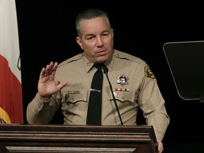 FILE - In this Dec. 3, 2018 file photo newly-elected Los Angeles County Sheriff Alex Villanueva speaks during a swearing-in ceremony in Monterey Park, Calif. Villanueva will limit when inmates in the county's jails can be transferred to federal authorities for deportation. Sheriff's Department spokeswoman Nicole Nishida said on Friday, Feb. 15, 2019,  the agency will reduce the number of misdemeanor charges that can trigger an inmate's transfer. She could not immediately say which misdemeanor charges would no longer qualify.