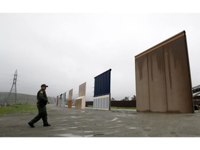 FILE - In this Feb. 5, 2019 file photo, Border Patrol agent Vincent Pirro walks towards prototypes for a border wall in San Diego. Customs and Border Protection said Friday, Feb. 22, 2019, President Trump's eight border-wall prototypes will be torn down to make way for a secondary barrier separating California from Mexico.