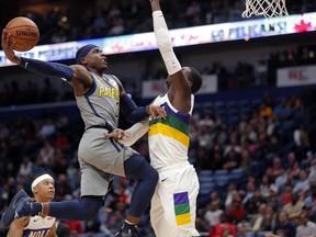 Indiana Pacers guard Aaron Holiday (3) goes to the basket against New Orleans Pelicans forward Cheick Diallo in the first half of an NBA basketball game in New Orleans, Monday, Feb. 4, 2019.