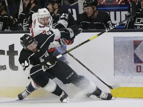 Los Angeles Kings' Derek Forbort, bottom, collides with Washington Capitals' Travis Boyd (72) during the first period of an NHL hockey game Monday, Feb. 18, 2019, in Los Angeles.