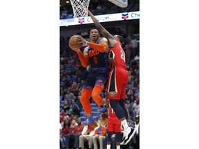 Oklahoma City Thunder guard Russell Westbrook (0) drives to the basket past New Orleans Pelicans forward Darius Miller (21) during the first half of an NBA basketball game in New Orleans, Thursday, Feb. 14, 2019.