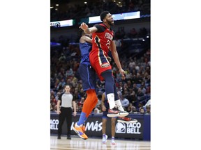 New Orleans Pelicans forward Anthony Davis (23) collides with Oklahoma City Thunder forward Nerlens Noel (3) after attempting to block a shot at the end of the first half of an NBA basketball game in New Orleans, Thursday, Feb. 14, 2019. Davis kept his left arm still as he walked to the locker room shortly after fouling Noel on an attempted shot block with his left hand. When the second half began, the Pelicans announced that Davis was out of the remainder of the game with a left shoulder injury, The Pelicans won 131-122.