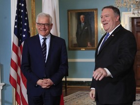 FILE - In this Monday, May 21, 2018 file photo, Secretary of State Mike Pompeo, right, meets with Polish Foreign Minister Jacek Czaputowicz at the State Department in Washington. The Polish government, which is closely aligned with President Donald Trump, has joined forces with the U.S. to co-host an international conference on the Middle East on Wednesday Feb. 12, 2019 and Thursday Feb. 13 in Warsaw, hoping to strengthen its ties with Washington as its seeks greater protection from Russia. The hosts are U.S. Secretary of State Mike Pompeo and Polish Foreign Minister Jacek Czaputowicz.