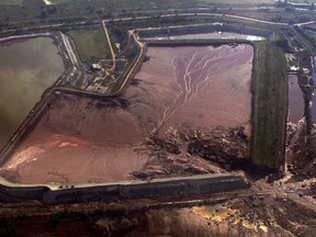 FILE - In this Monday, Oct. 11, 2010 file photo, the damaged reservoir of an alumina plant is seen from the air near the village of Kolontar, Hungary. A Hungarian court on Monday Feb. 4, 2019, has sentenced to prison two former executives of an alumina plant involved in the 2010 red sludge flood, an industrial disaster which killed eight people and injured over 220.