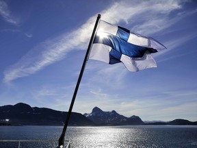 FILE - In this Saturday, July 29, 2017 file photo, Finland's flag flies aboard the Finnish icebreaker MSV Nordica as it arrives into Nuuk, Greenland. A nationwide experiment with basic income in Finland has not increased employment among those participating during the first half of the two-year trial, but their general well-being seems to have increased, a report said Friday Feb. 8, 2019.