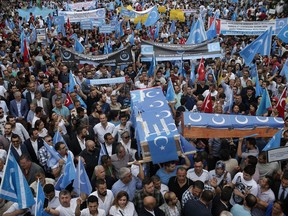 FILE - In this Saturday, July 4, 2015 file photo, Uighurs living in Turkey and their supporters, some carrying coffins representing Uighurs who died in China's far-western Xinjiang Uighur region, chant slogans as they stage a protest in Istanbul, against what they call as oppression by Chinese government to Muslim Uighurs in the province. In a statement Saturday Feb. 9, 2019, Turkey's foreign ministry has called China's treatment of its minority Uighurs "a great cause of shame for humanity." The Foreign Ministry spokesman Hami Aksoy said it's "no longer a secret" that China has arbitrarily detained more than a million Uighurs in "concentration camps."