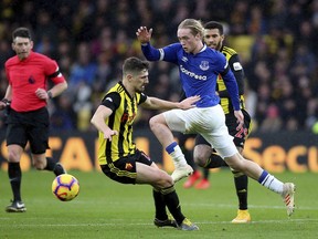 Watford's Craig Cathcart, left, and Everton's Tom Davies battle for the ball during the English Premier League soccer match at Vicarage Road, Watford, England, Saturday Feb. 9, 2019.