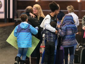 Lisa Honorat and her daughter Miesha, 12, are greeted by relieved family members after arriving back in Calgary on Sunday February 17, 2019. The two were among a group of Haiti Arise members who used a helicopter to evacuate after violent protests shook the country.