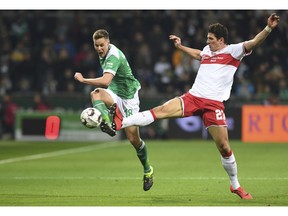 Werder's Niklas Moisander, left, battles against Stuttgart's Mario Gomez for the ball during the German Bundesliga soccer match between Werder Bremen and VfB Stuttgart in Bremen, Germany, Friday, Feb. 22, 2019.