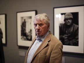 Veteran British conflict photographer Don McCullin poses for photographers at the launch of his retrospective exhibition at the Tate Britain gallery in London, Monday, Feb. 4, 2019. The exhibition includes over 250 of his black and white photographs, including conflict images from the Vietnam war, Northern Ireland, Cyprus, Lebanon and Biafra, alongside landscape and still life images.