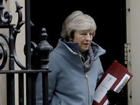 British Prime Minister Theresa May leaves 10 Downing Street in London, to attend Prime Minister's Questions at the Houses of Parliament, Wednesday, Feb. 13, 2019.